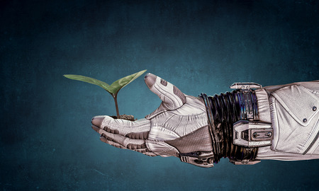 Hand of astronaut and green sprout. Mixed mediaの写真素材