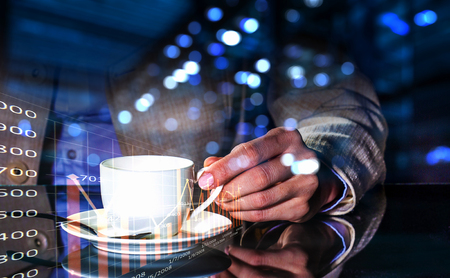 Double exposure of businessman holding cup of coffee and modern cityscapeの写真素材