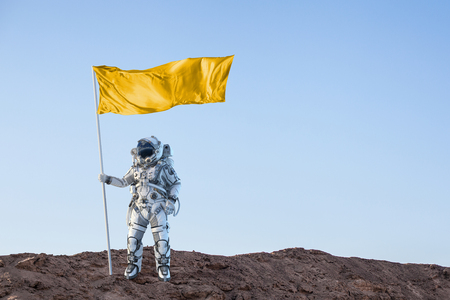 Astronaut man with flag in hand. Mixed media