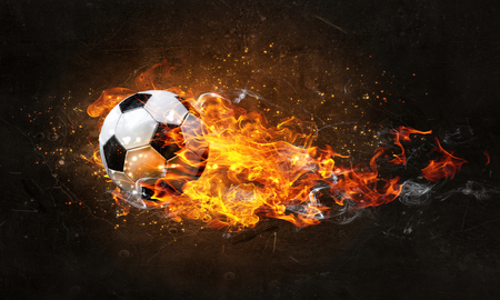 Concept of soccer game with ball in fire flames. Mixed mediaの写真素材
