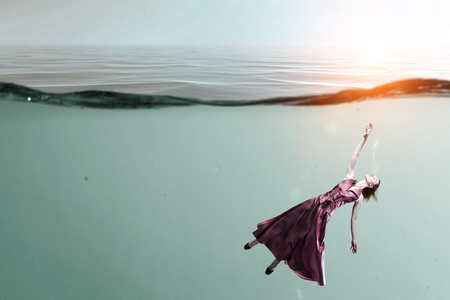 Woman dancer in clear blue waterの写真素材