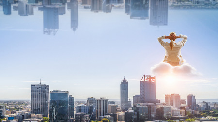 Woman float above cityの写真素材