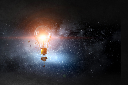 Glass bulb in dark sky. Mixed mediaの写真素材