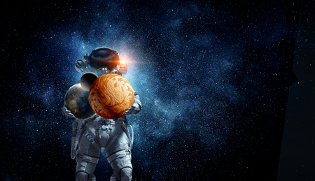 Spaceman carry big planet. Mixed mediaの写真素材