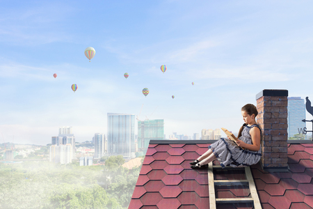 Beautiful girl reading book. Mixed mediaの写真素材