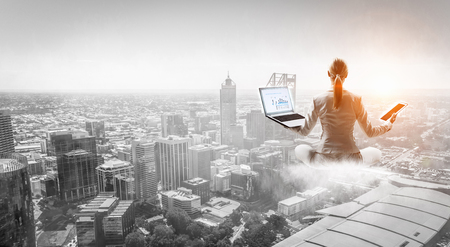 Woman float above cityの写真素材