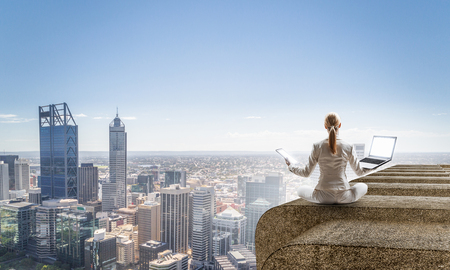 Woman float above city. Mixed mediaの写真素材