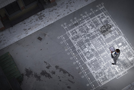 Man engineer thinking over his plan. Mixed mediaの写真素材