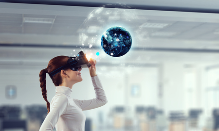 Experiencing virtual technology world. Mixed mediaの写真素材