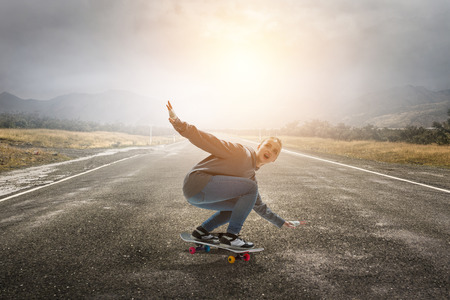 Teenager girl ride her skateboard. Mixed mediaの写真素材