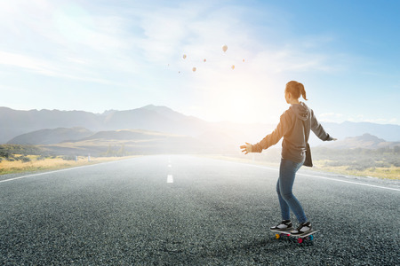 Teenager girl ride her skateboard. Mixed mediaの写真素材
