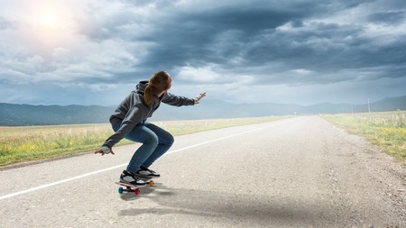 Teenager girl ride her skateboard. Mixed mediaの写真素材