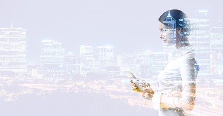 Attractive business lady working on tablet . Mixed mediaの写真素材