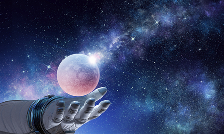 Moon planet in spaceman hand. Mixed mediaの写真素材