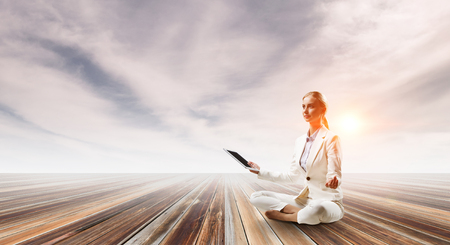 Businesswoman in lotus pose. Mixed mediaの写真素材