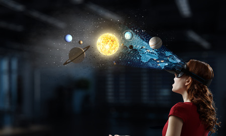 Attractive woman in red dress wearing virtual helmet. 3d rendering