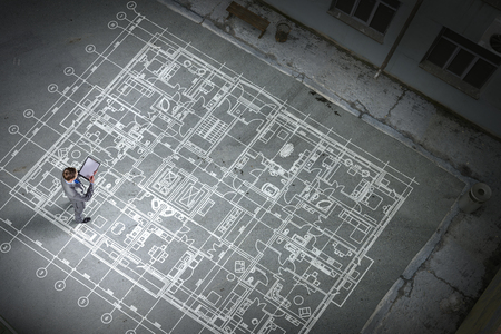 Man engineer thinking over his plan. Mixed mediaの写真素材
