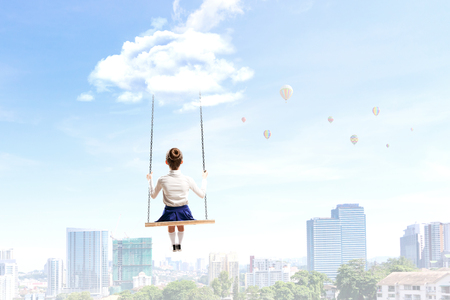 Cute little girl riding on swing. Mixed mediaの写真素材