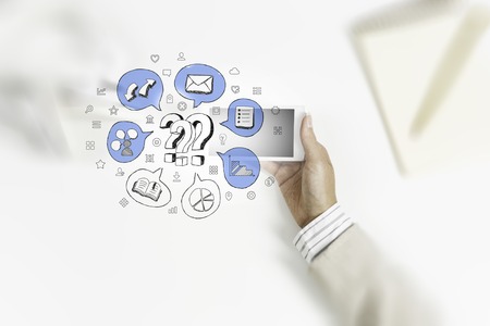 Top view of woman sitting at table and using smartphoneの写真素材