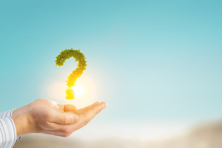 Hands of businessman holding green question markの写真素材