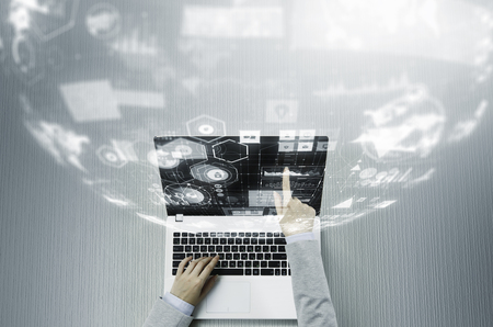 Top view of businesswoman sitting at table and working with laptopの写真素材