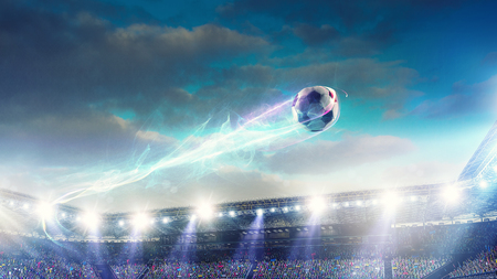 Soccer stadium background with flying ballの写真素材