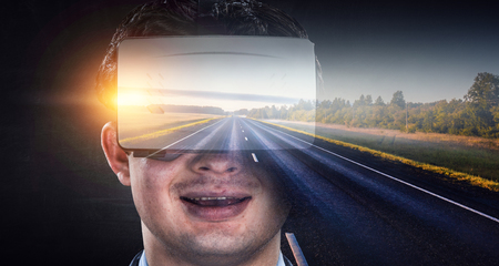 Man in VR glasses travels to virtual worldの写真素材