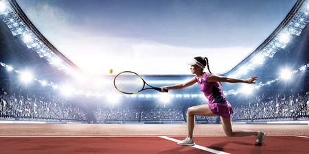 Young woman playing tennis in action. Mixed mediaの写真素材