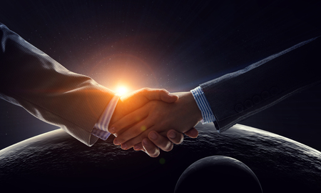 Business handshake by a man and a woman. Mixed mediaの写真素材
