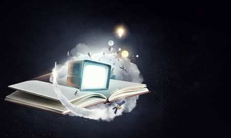 Open blank notebook and a vintage tv on space fantasy backgroundの写真素材