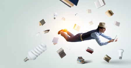 Smiling joyful levitating young man. Mixed mediaの写真素材