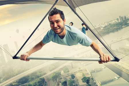 Young man flying on hang glider. Mixed mediaの写真素材