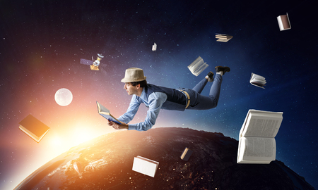 Smiling joyful levitating young man. Mixed mediaの写真素材