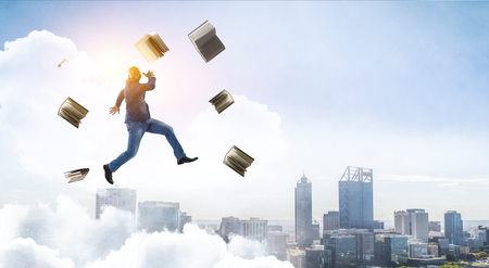Joyful black man wearing casual clothes jumping. Mixed mediaの写真素材