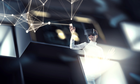 Young female in virtual reality. Mixed mediaの写真素材