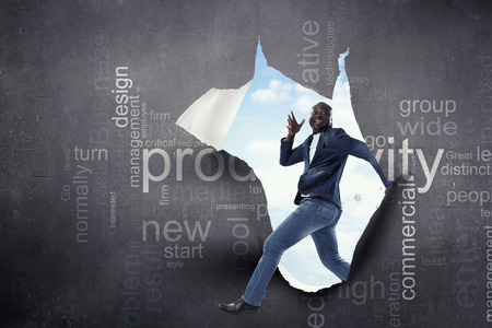 Joyful walking black man wearing casual clothes. Mixed mediaの写真素材