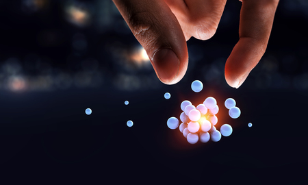 Businessman hand holding a bunch of spheres levitating above. Mixed mediaの写真素材