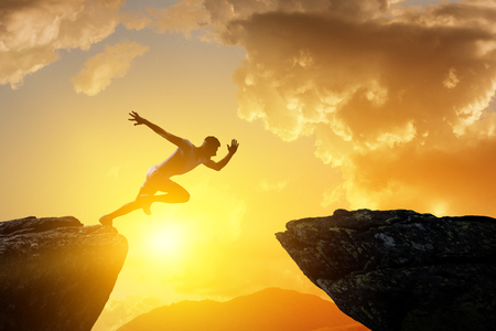 Jumping over precipice, challenge concept.の写真素材