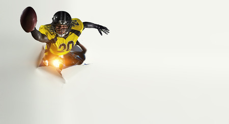 Paper breakthrough hole effect and american footballの写真素材