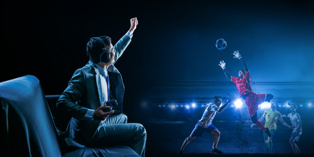 Businessman playing football video gameの写真素材