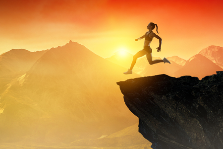 Jumping over precipice, challenge concept.の写真素材