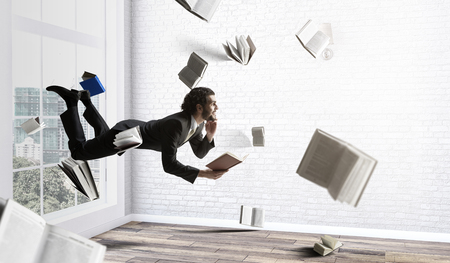 Joyful happe businessman levitating horizontallyの写真素材