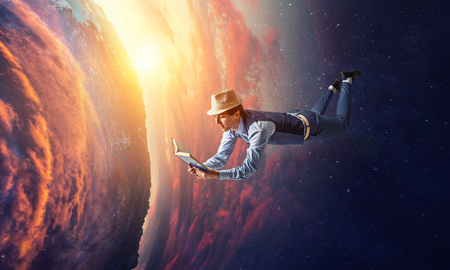 Smiling joyful levitating young man. Mixed mediaの写真素材