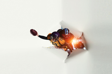 Paper breakthrough hole effect and football player. Mixed mediaの写真素材