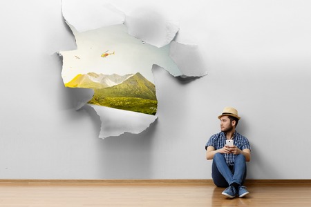Young man sitting on the floor, a moment for relax concept. Mixed mediaの写真素材