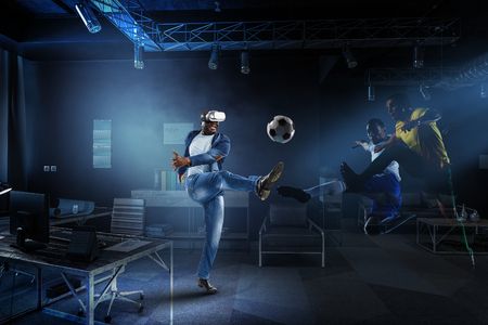 Virtual Reality headset on a black male playing soccerの写真素材