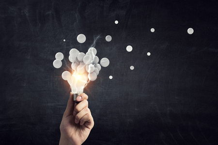 Pixelated light bulb. Development concept. Mixed mediaの写真素材