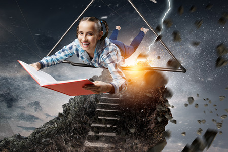 Young woman flying on hang glider. Mixed mediaの写真素材