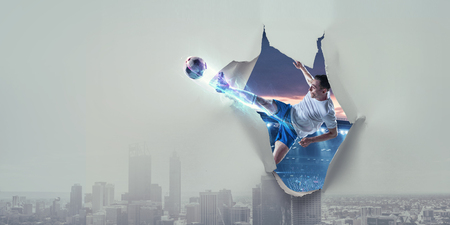 Paper breakthrough hole effect and soccerの写真素材