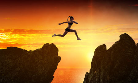 Jumping over precipice, challenge concept.の写真素材